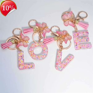 Porte-clés en résine rose avec lettres initiales, pendentif papillon, pompon, pour filles et femmes, sacs à main, clés de voiture, accessoires, nouvelle collection