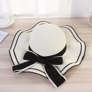 Nieuwe zomer brede rand hoeden golvend bowknot riem stro hoed dames strand zon bescherming caps voor vakantie