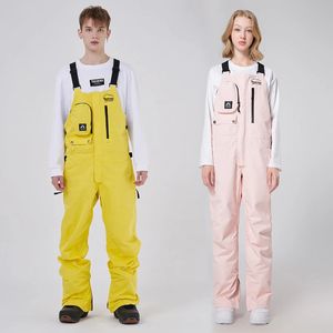 Outdoor Mountain Men Sneeuw Jumpsuit Waterdichte vrouw Skiing broek Sport Women Ski overalls Suspene vrouwelijke wandelbroeken 231221