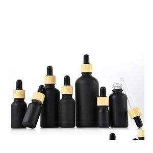 Bouteilles d'emballage Flacon compte-gouttes en verre enduit noir mat Boston huiles essentielles rondes par avec bouchon en plastique de grain de bois livraison directe d'otdqa