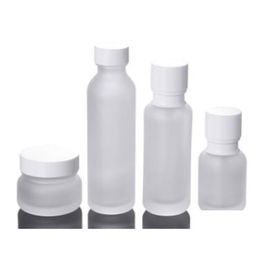 Bouteilles d'emballage Bouteilles d'emballage en gros Pot en verre dépoli Lotion Crème ronde Pots cosmétiques Bouteille à pompe pour le visage à la main avec grain de bois C Dh1Wy