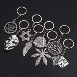 Gepersonaliseerde en modieuze hiphop-sleutelhanger zespuntige stermaskervleugels metalen hanger rond label trendy creatief cadeau voor mannen