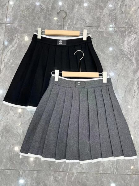 Vestidos de talla grande para mujer, faldas negras sexys informales de diseñador, de cintura alta, de metal para evitar que se apague la minifalda, novedad de 2023