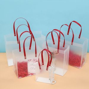 Bolsa de plástico PP con mango rojo PVC Bolsa de regalo de heladas transparentes para la fiesta de la boda al por mayor LX6039