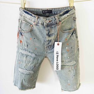 Jeans de marca morados estilo americano con bordes ásperos y agujeros shorts de mezclilla lavados para hombre