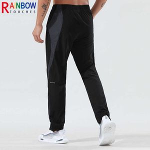 Rainbowtouches hommes haute élasticité séchage rapide anti-rides poche zippée deux couleurs épissage pantalons de sport décontractés qualité supérieure Y0811