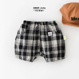 Shorts 2024 Été South Coréen Ins Baby Boys Shorts pure Coton Pocket Souriant visage Autocollant Baby Boys Shorts Préscolaires Boys Set D240510