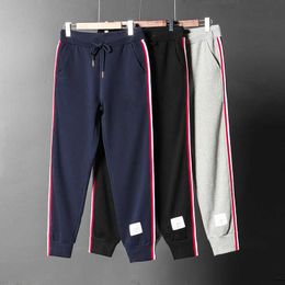 Mallas con cierre de tendencia con correas laterales para hombres y mujeres, pantalones deportivos informales de algodón puro de marca de moda, pantalones protectores de pies pequeños para parejas