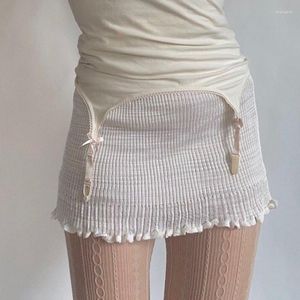 Jupes 2023 été femmes vêtements creux couleur unie blanc taille haute minceur oreilles en bois serré Mini jupe courte Streetwaer