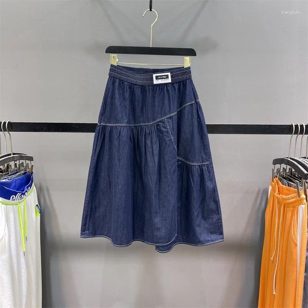 Jupes jupe en jean bleu foncé pour les femmes en été mince taille élastique couture irrégulière grand ourlet a-ligne mi-longueur