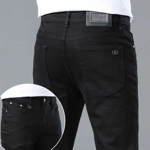 Lente 2023 dunne heren jeans Koreaanse editie slanke high -end Europese pure zwarte jeugd broek