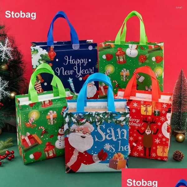 Sacs de rangement Stobag 12pcs Joyeux Noël Non-tissé Fourre-tout Emballage cadeau Tissu imperméable Bonbons réutilisables Grandes pochettes Party Drop Deli DH6ML