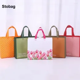 Sacs de rangement Stobag 25pcs en gros de toters de magasinage non tissés vêtements d'emballage portable imperméable grand réutilisable à la maison