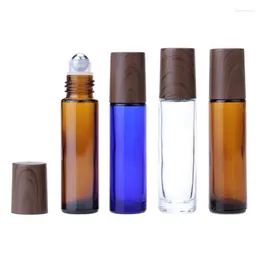 Botellas de almacenamiento 100pcs de perfume masaje botella de vidrio marrón 10 ml rodillo de acero negro tapa de madera falsa rollo azul vacío para aceite esencial