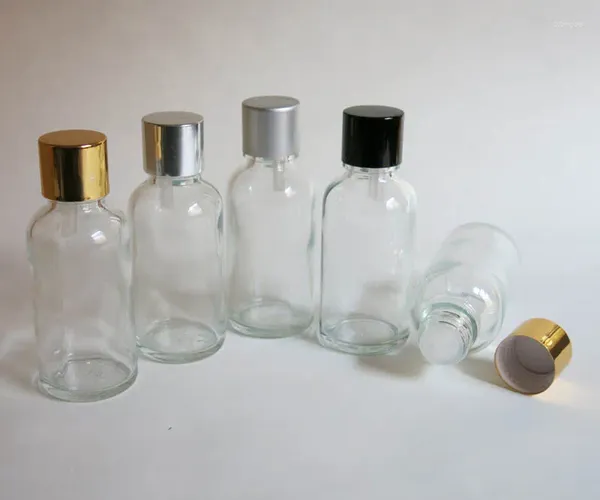 Bouteilles de stockage 100pcs en gros 30ml bouteille en verre transparent avec compte-gouttes réducteur et couvercle inviolable vis sur huile essentielle