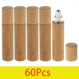 Bouteilles de rangement 60pcs 10 ml d'huile essentielle bouteille de bambou en verre coque en verre inner avec récipient de parfum de voyage à rouleau en acier en acier inoxydable