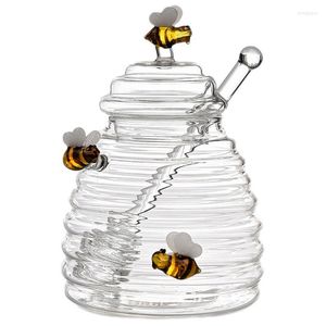 Distributeur de verre de pot de miel de bouteilles de stockage avec le couvercle transparent de louche Pot de miel unique de forme de ruche d'abeille