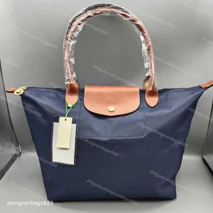 Liquidación de tienda Venta al por mayor 95% de descuento en bolsos grandes Venta al por menor sac a main Venta al por mayor Mujeres Versión alta 70.o bolso de aniversario de mano Bolsas de ocio con capacidad de bola de masa