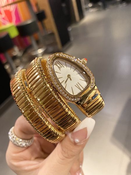 La montre pour femme de 32 mm a un mouvement à quartz en forme de serpent à double contour avec un mouvement de lunette en diamant. Accessoires de mode pour dames.