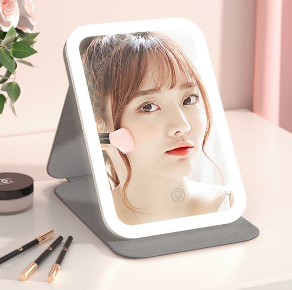 Le dernier miroir de courtoisie éclairé 20.2X13.8CM Miroir de maquillage LED avec lumières tricolores chargeant de nombreuses options de couleur prenant en charge le logo personnalisé