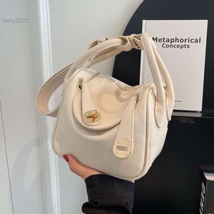 Totes Bolsos de lujo para mujer, nueva textura, bolsos de hombro tipo cubeta de cuero PU para fiesta, elegante bolso de mano con diseño de bloqueo de borlas a la moda para mujer