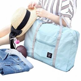 Sacs de voyage Sacs de vitesses pour femmes Nouveaux sacs à main portables pliables nylables sacs de rangement en lage.