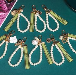 Keychain Clécherie de clés de luxe de luxe Clées pendantes clés boucle classique lettre tissu chaîne de perles 4 styles sacs clés de haute qualité Orn6299700