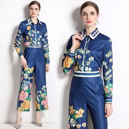 Tweedelige set dames designer bloemenfeest blauwe broeksets 2023 lente herfst lange mouwen revers knop print shirt en wijde pijpen broek vakantiekostuums kantoor dame outfit