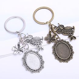 Vintage metalen sleutelhangers 18 * 25mm ovale cabochon instelling diy sieraden maken bloem uil sleutelhanger voor vrouwen 5 stuks / partij
