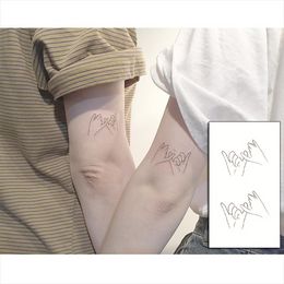Autocollant de tatouage temporaire étanche motif de crochet de traction Couple adulte bras jambe faux tatouage hommes et femmes