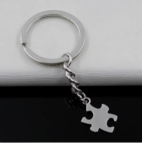 L'argento dei monili di Keychain dell'anello chiave di modo ha placcato i fascini della parte di puzzle