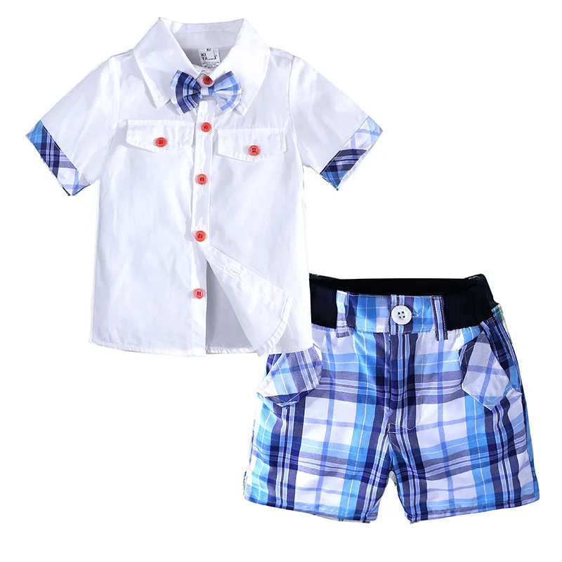 Set di abbigliamento per bambini Abiti estivi Set di abbigliamento per ragazzo Camicia bianca con papillon + Pantaloncini a griglia Pantaloni Set di vestiti per bambini