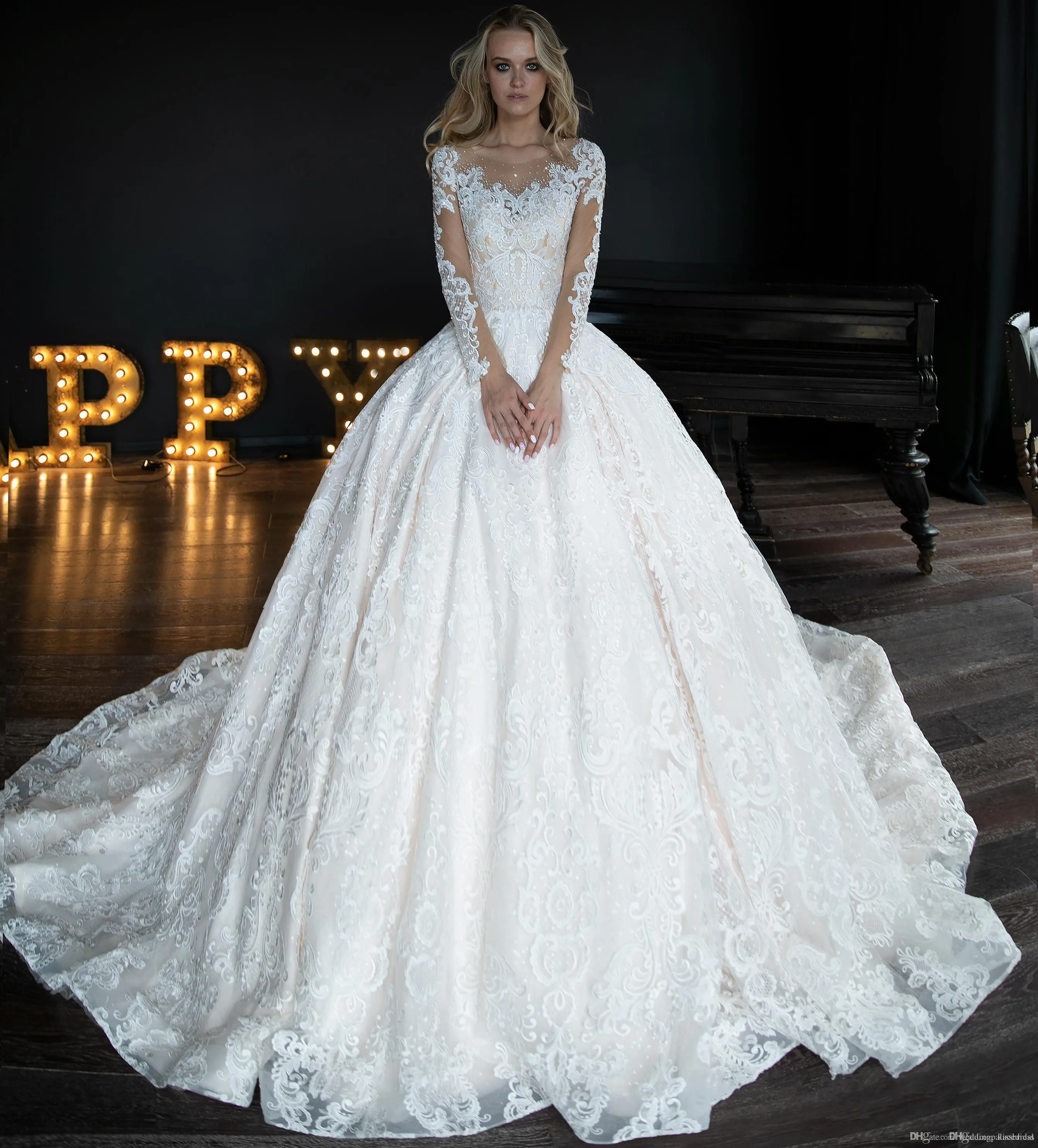 Lacet a une élégante robe de lignes transparentes manches longues perlé robin de trains de cour cristalline robe de mariée robes de mariée