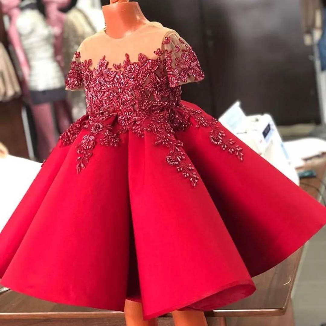 Vestidos de niña de flores de línea A con cuentas rojas para bodas Cuello de joya transparente Mangas cortas Vestidos de desfile para niños pequeños Vestido de fiesta de satén para niños