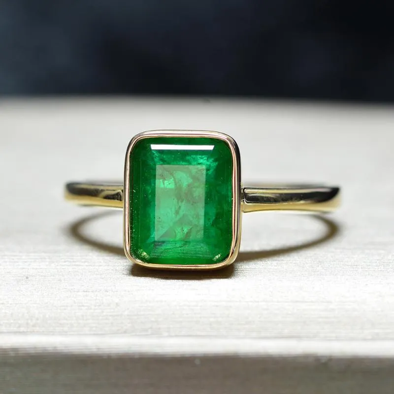 14KT Yellow Gold Ring with a green stone placed at the centre