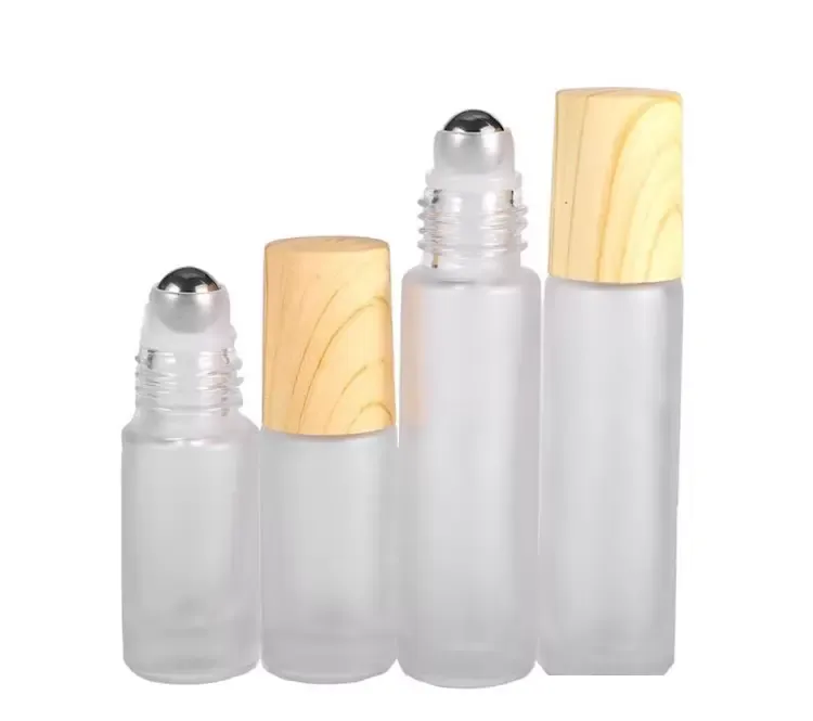 2022 Novos recipientes de frascos de frascos de rolos de vidro claros com bola de rolos de metal e tampa de plástico de grão de madeira para perfume de óleo essencial 5ml 10ml