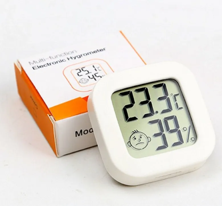 Digital Hygrometer With Thermometer On Wooden Table Indoors Stock Photo