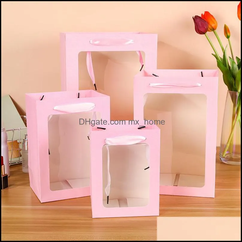 Stock Valentine`s Day birthday Gift Wrap Skylight paper bag with hand bag Open window transparent flower