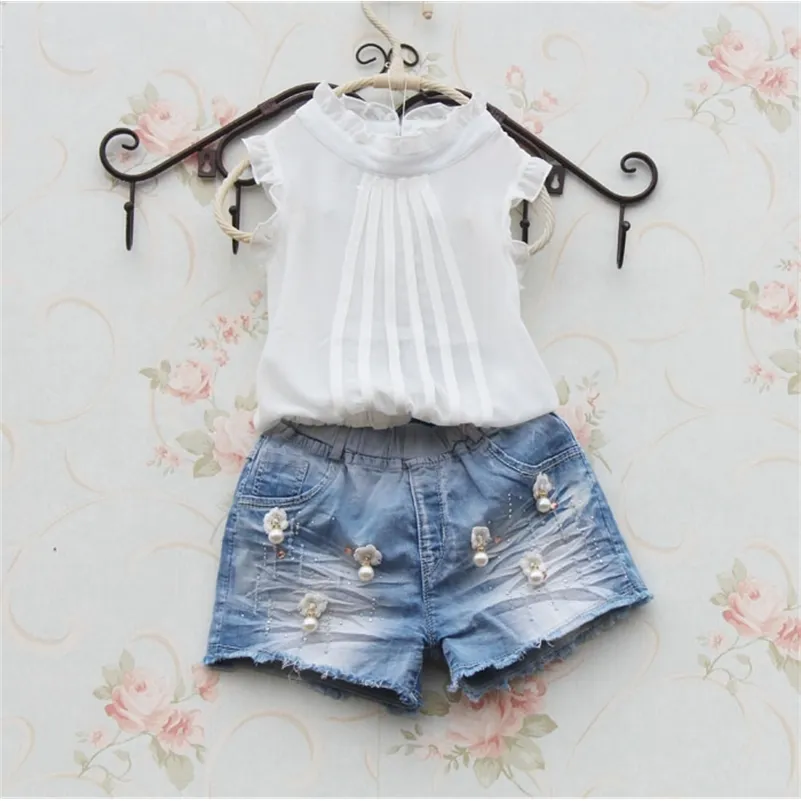 女の子の白いシャツのノースリーブのシフォンテープのための幼児の子供服のための涼しいシャツ210306