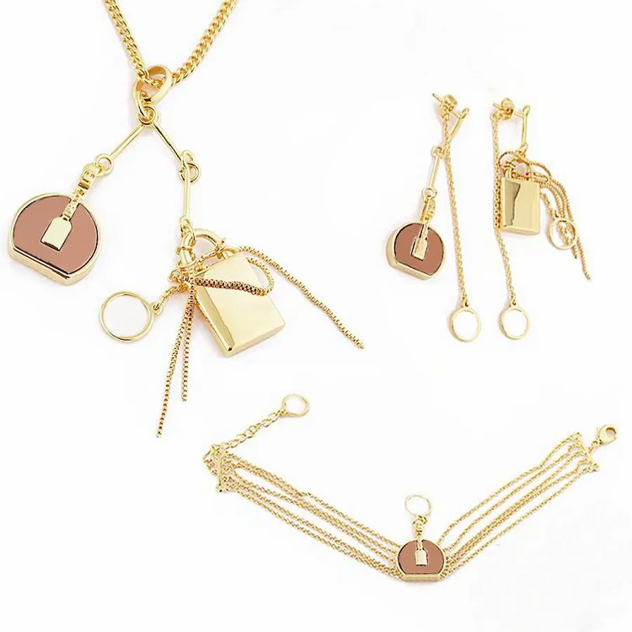 Europa America Set di gioielli di moda Lady Womens Metallo color oro con incisione V Iniziali Fiore Nappe Collana con ciondolo Bracciale Orecchini NNV