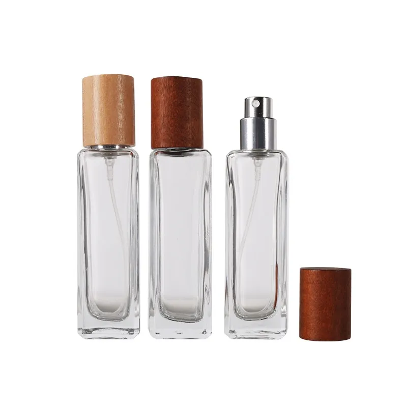 Tapa de madera Bayoneta Cerradura Spray Botella de perfume Bomba de plata dorada 30 ml Cuadrado Vidrio transparente Fondo grueso Envases cosméticos Viales recargables