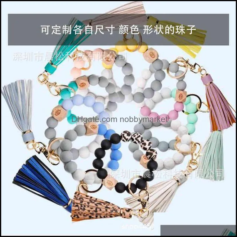 Women`s tassel wood bead silicone bracelet key chain food grade