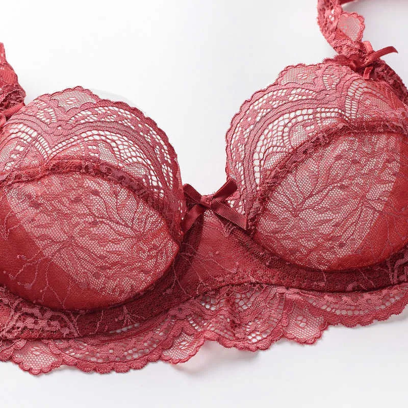 Details of red lace bra in female hand. Fashion lingerie concept