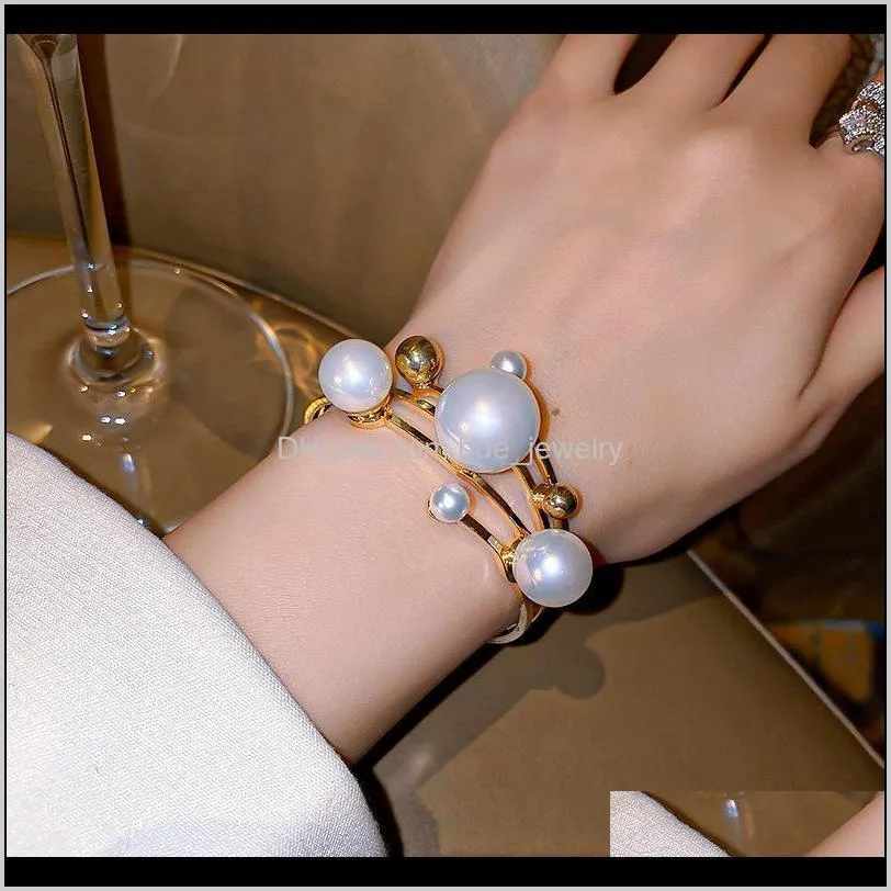 Armband juvelrysminar elegant överdimensionerad simulerade pärlkuffarmband för kvinnor guldfärg metall skiktad ihålig oregelbunden charm armband aessori