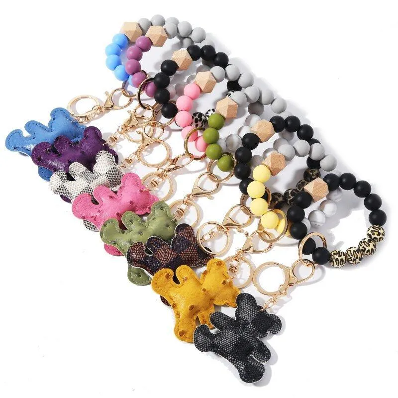 8 Styles Silicone Bead Bracelet Keychain Party Wooded Beads Keyring Old Flower Plaid Bear Decoration Key Ring PU Leather Ornament Bag Pendant DH8975
