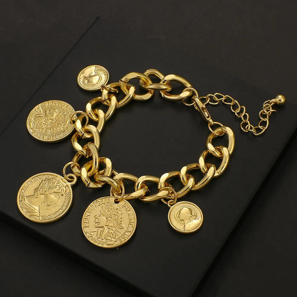 LOT:77 | A GOLD COIN CHARM BRACELET, formed as seven graduated gold coins  and a pendant, each contained within circular bezel and joined by bar-link  chain (stamped .750) comprising: An Austrian 4