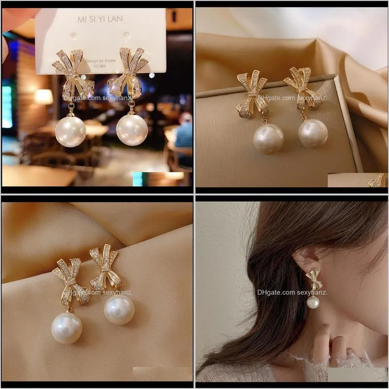 elegant women`s bow earrings pearl pendant silver pin with cubic zircon