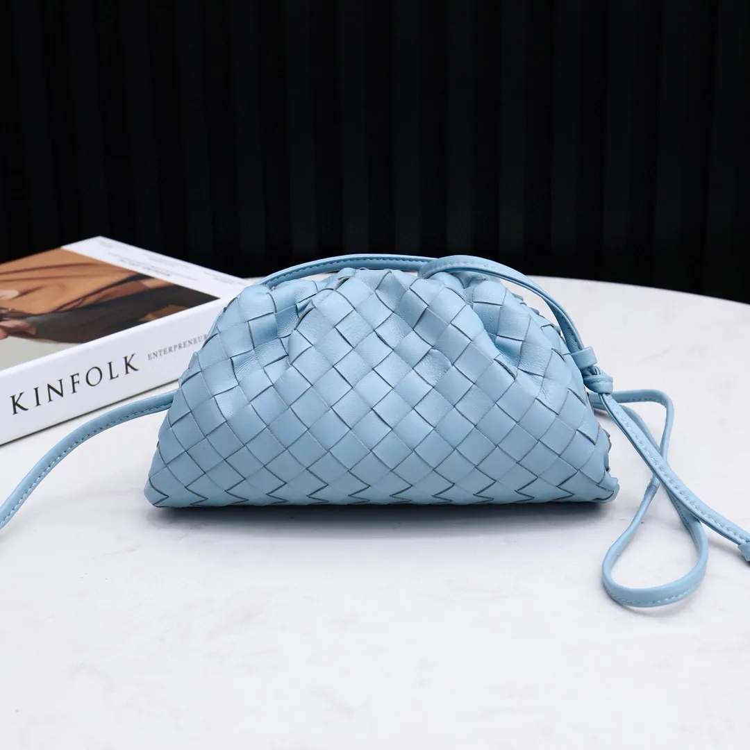 Designer clutch with hand strap clearance