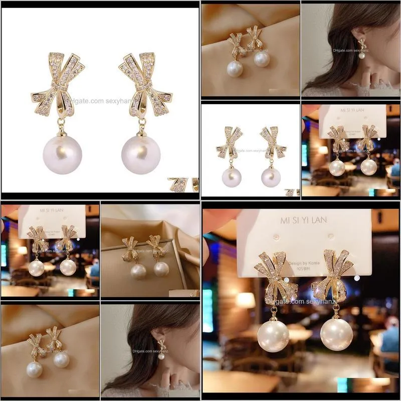 elegant women`s bow earrings pearl pendant silver pin with cubic zircon