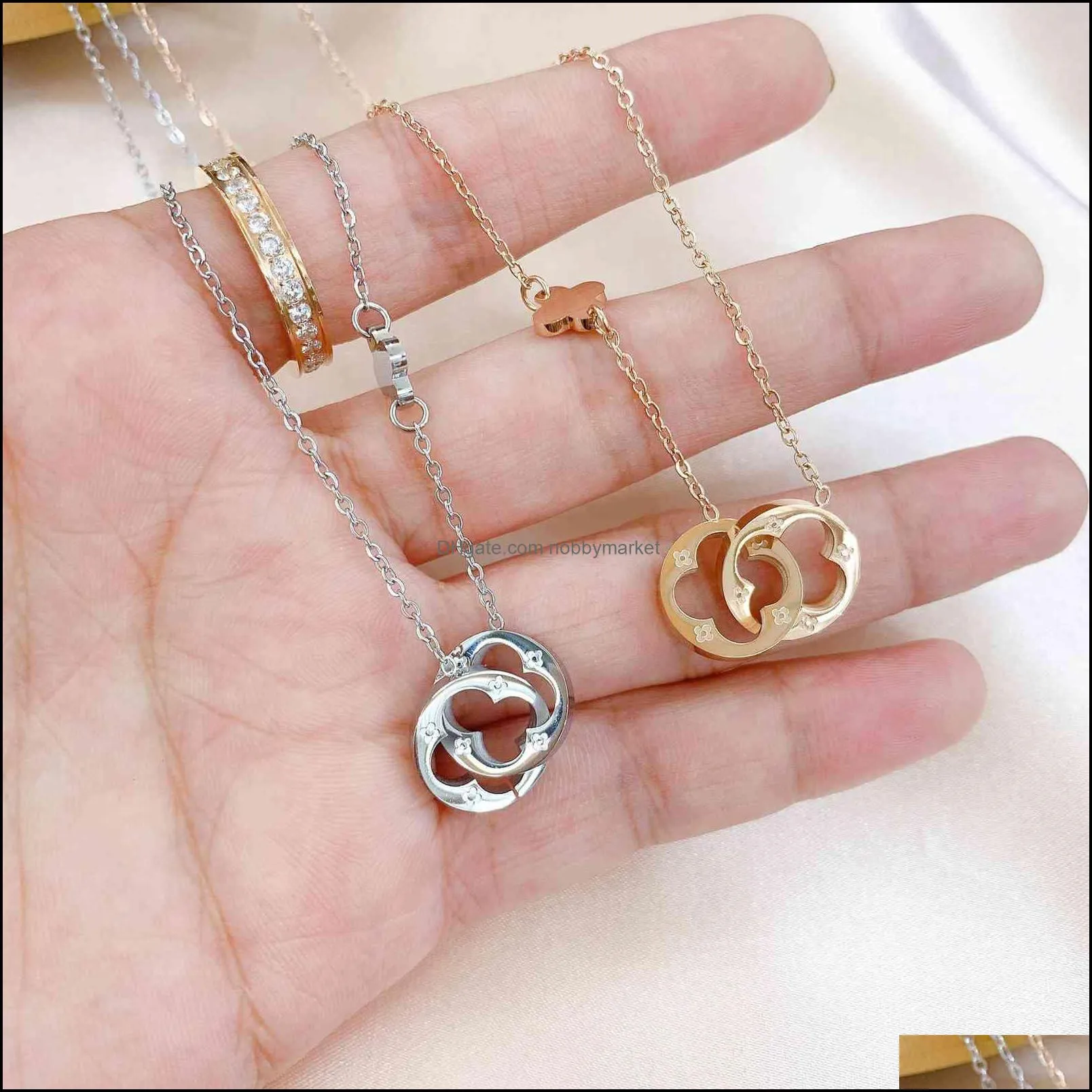 Korean double ring hollow out Clover Necklace female titanium steel 18K Gold simple buckle lucky grass clavicle chain neck